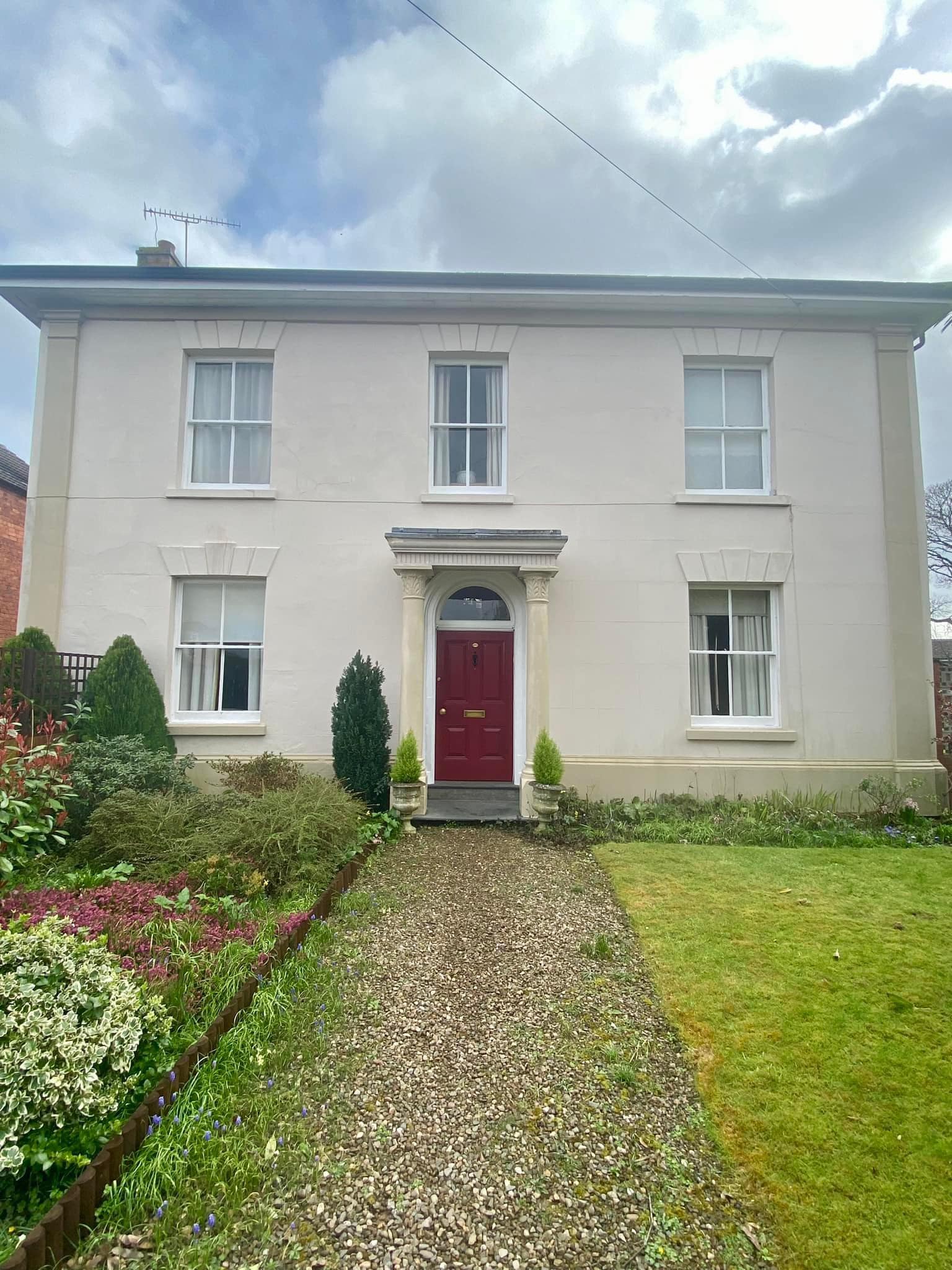 Wooden windows repaired and painted. Exterior porch columns also painted.